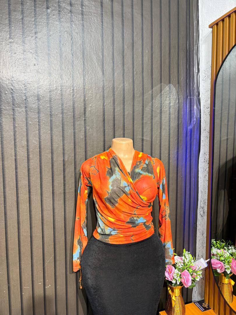 Cross-wrap mesh long-sleeve top.