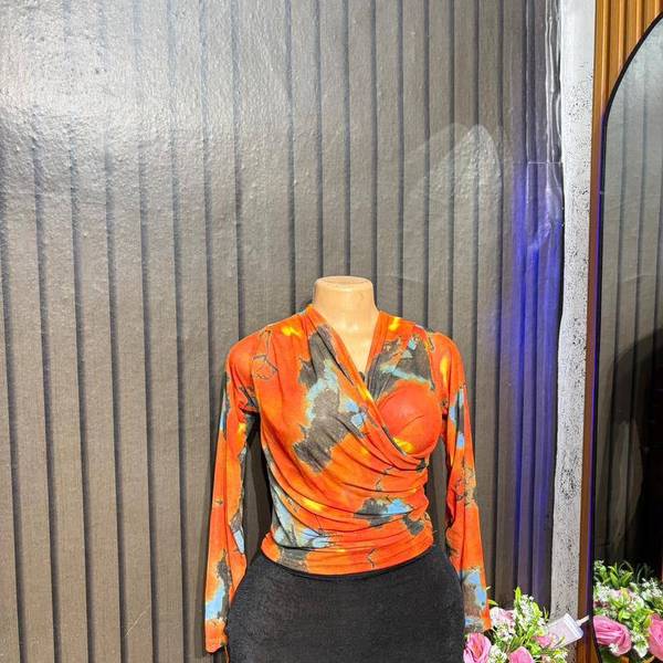 Cross-wrap mesh long-sleeve top.